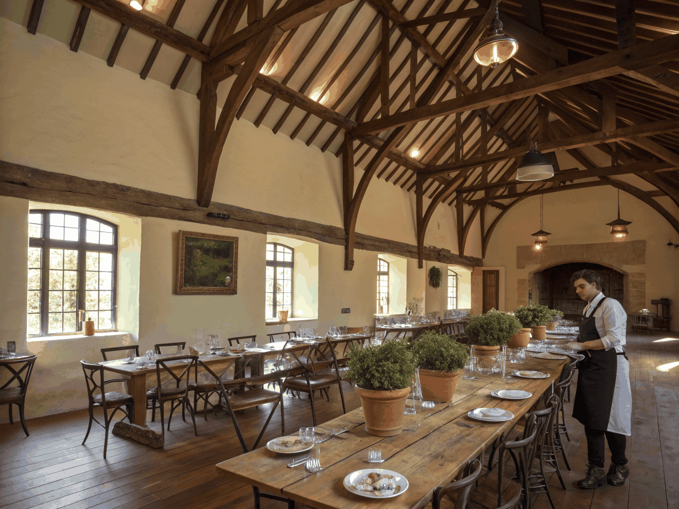 Spacious dining hall with warm oak furniture